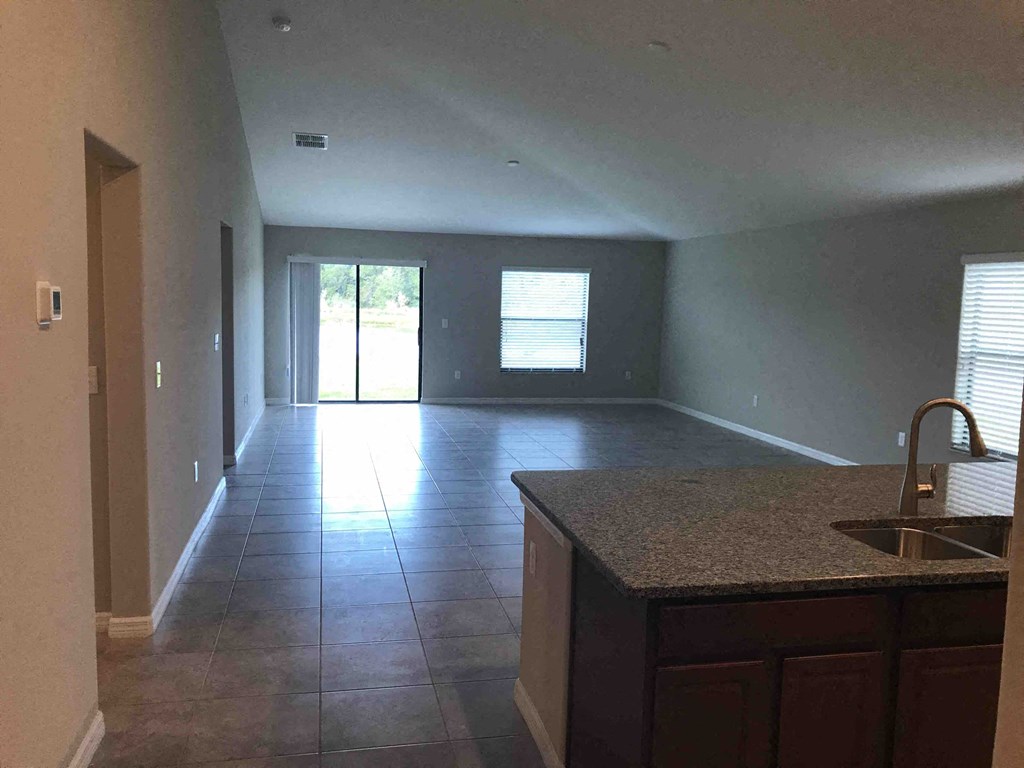an empty kitchen and living room in a house