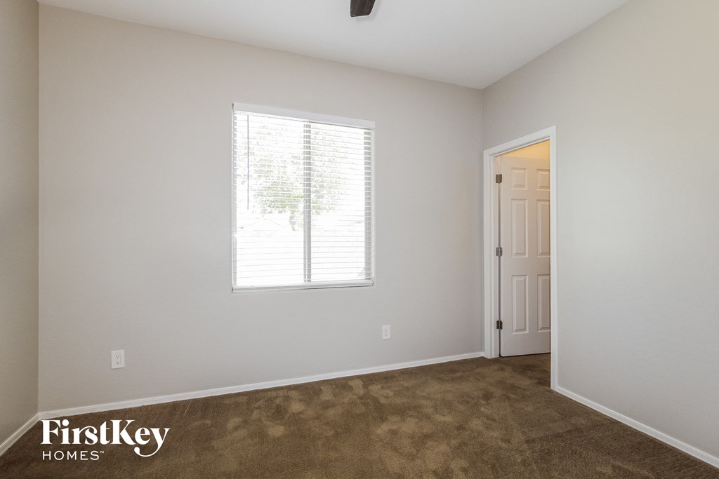 a living room with carpet and a window and a door