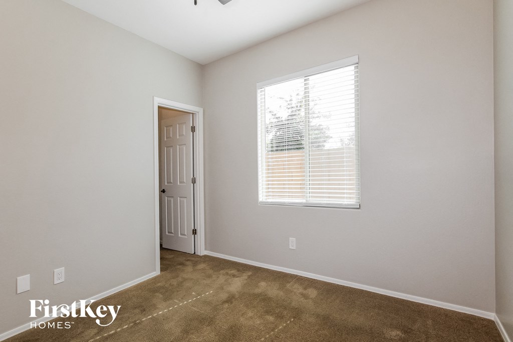 the living room of a home with a carpet and a window