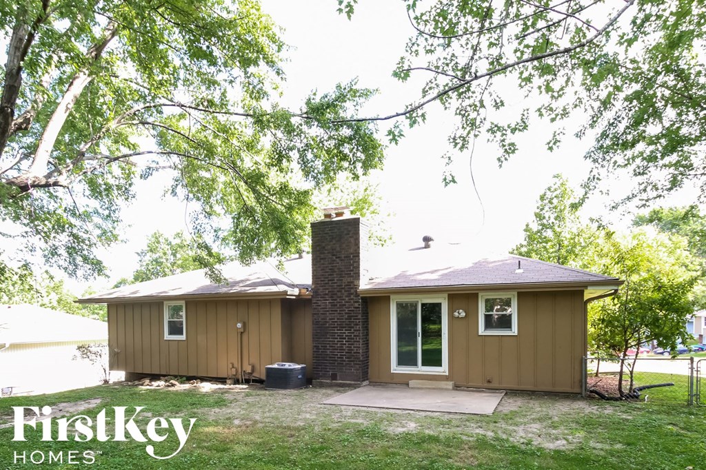 the exterior of a house with a brick chimney on the side