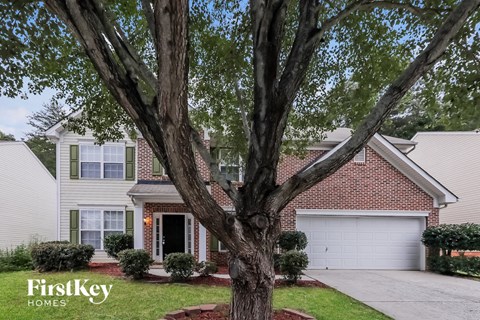 a house with a large tree in front of it
