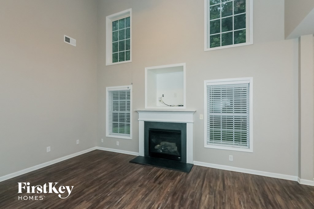 the living room of a new home with a fireplace