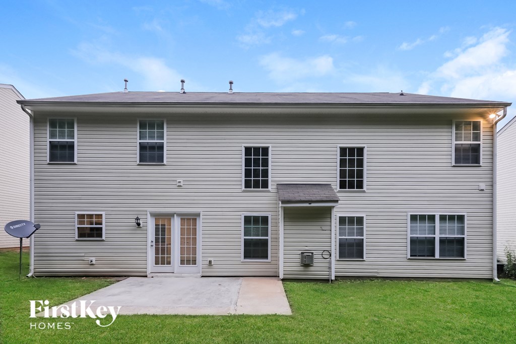 an old with a driveway and grass