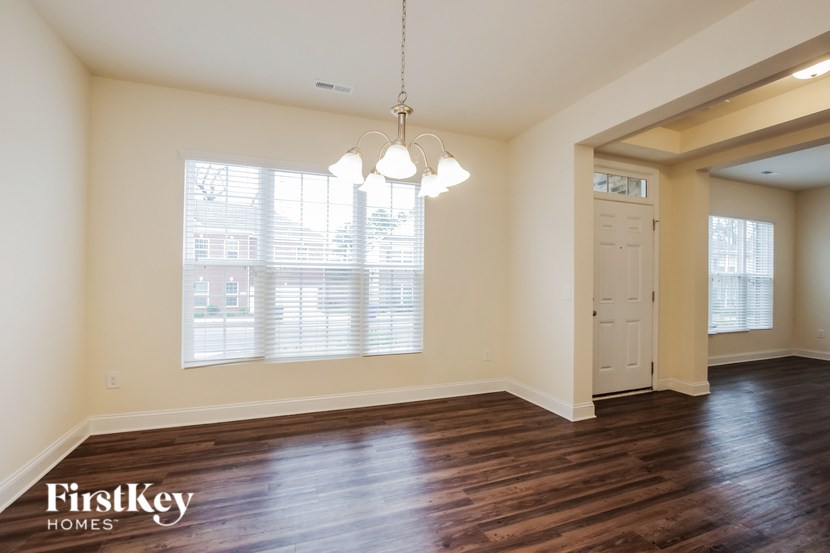 A room with wooden floors and a white door.