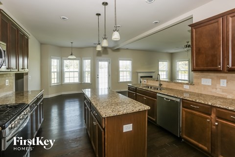 A kitchen with wooden cabinets and granite countertops.
