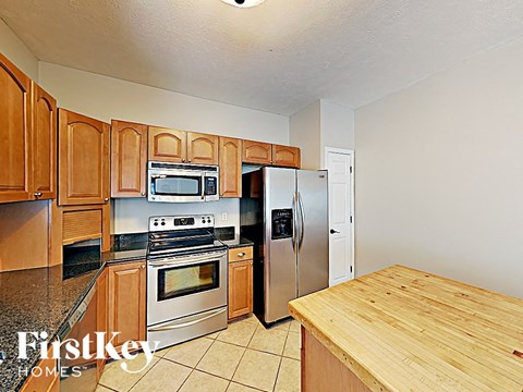 a kitchen with stainless steel appliances and wooden cabinets