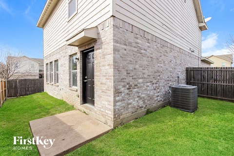 the outside of a house with a walkway and grass