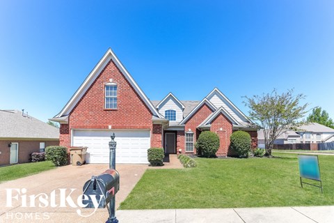 a brick house with a blue mailbox in front of it