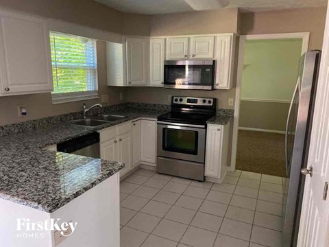 A kitchen with granite countertops and stainless steel appliances.