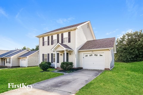 A two-story house with a garage is for sale by FirstKey Homes.