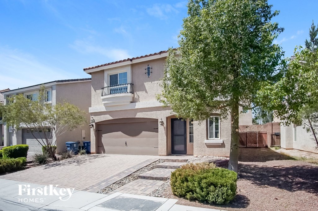 a beige house with a tree in front of it