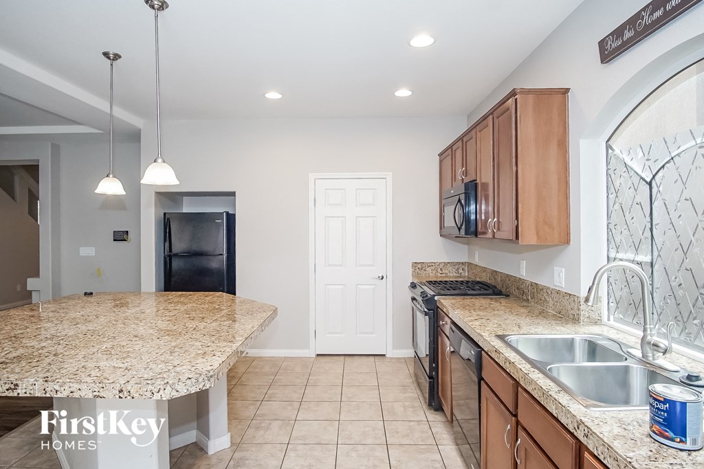 a kitchen with granite counter tops and a sink