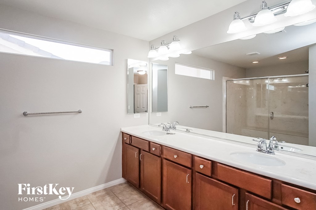 a bathroom with two sinks and a large mirror