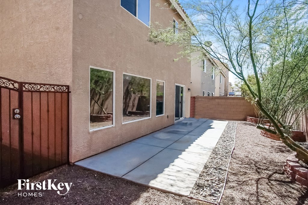the front entrance to a home with a sidewalk and a gate