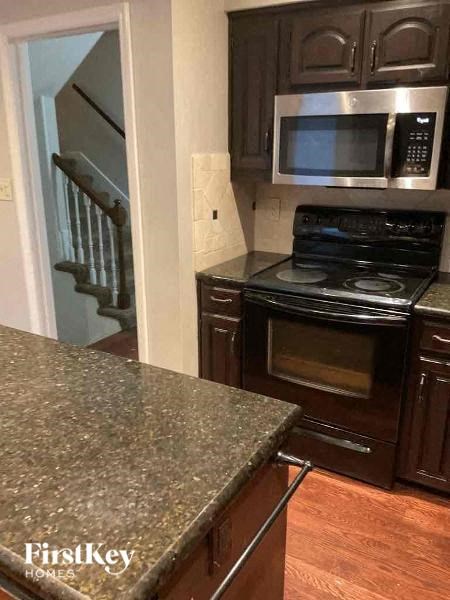 a kitchen with a stove and a microwave