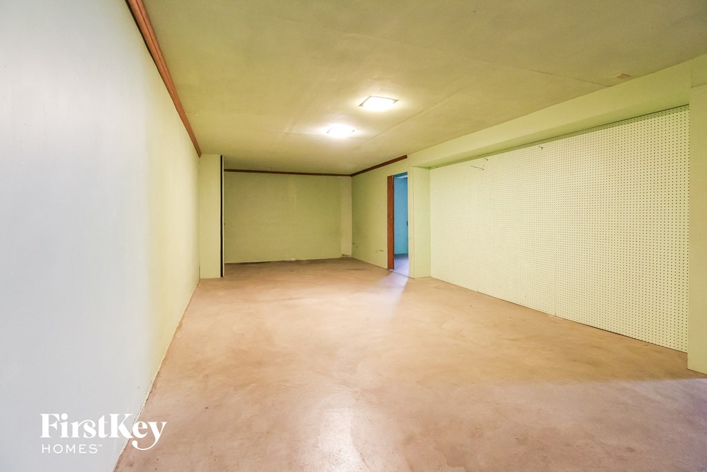 an empty room in a building with white walls and a tile floor