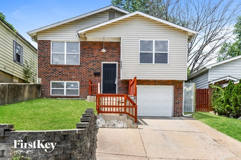 a brick and with a white garage door