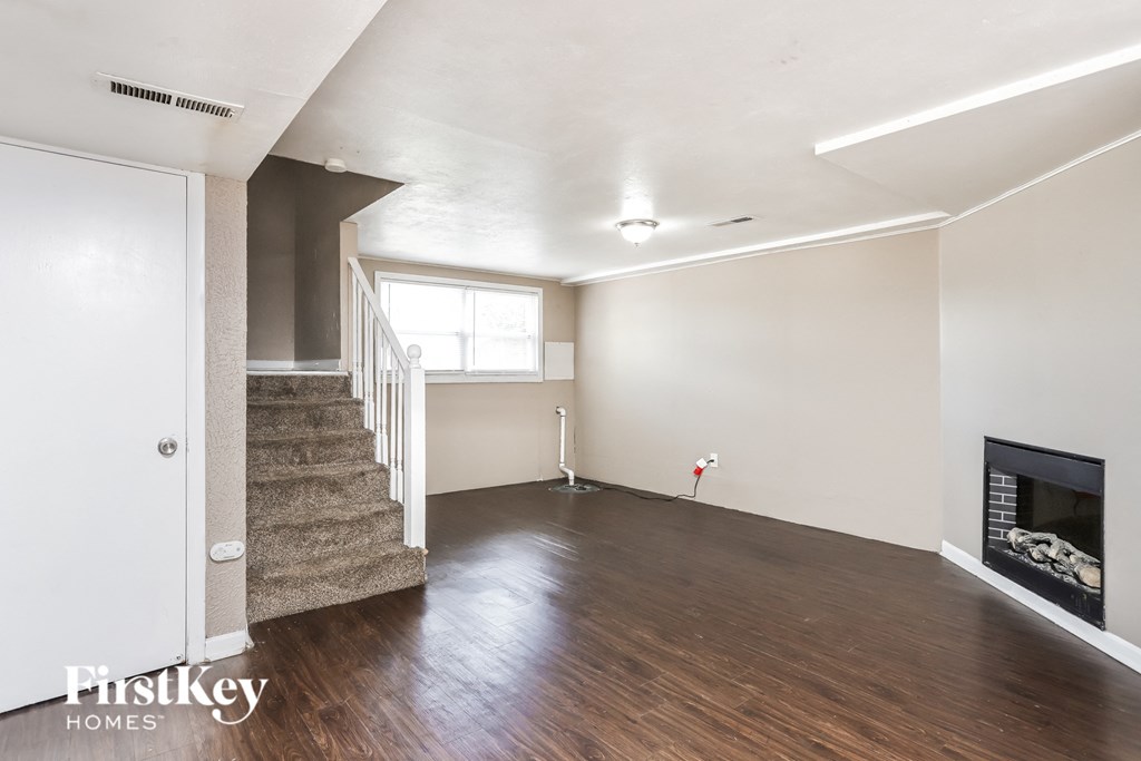 a living room with wood flooring and a fireplace