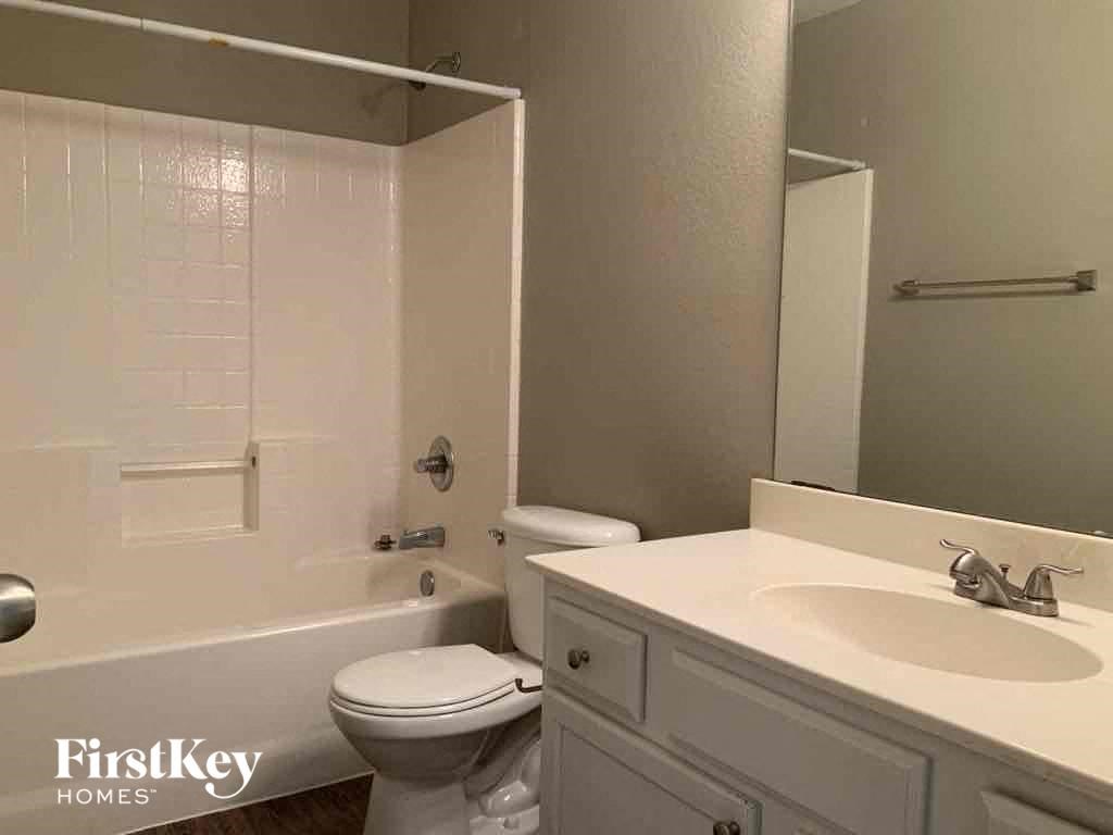 a white bathroom with a sink toilet and tub
