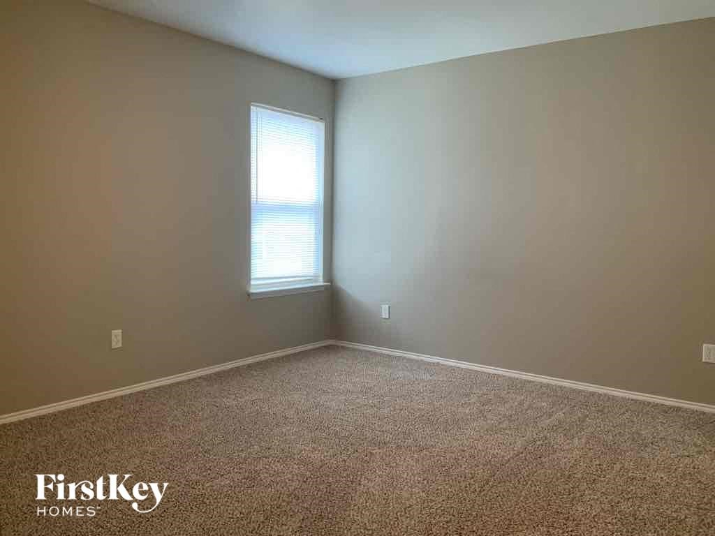 an empty room with carpet and a window