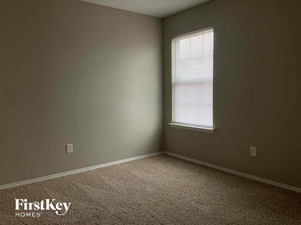 a room with a window and a carpet