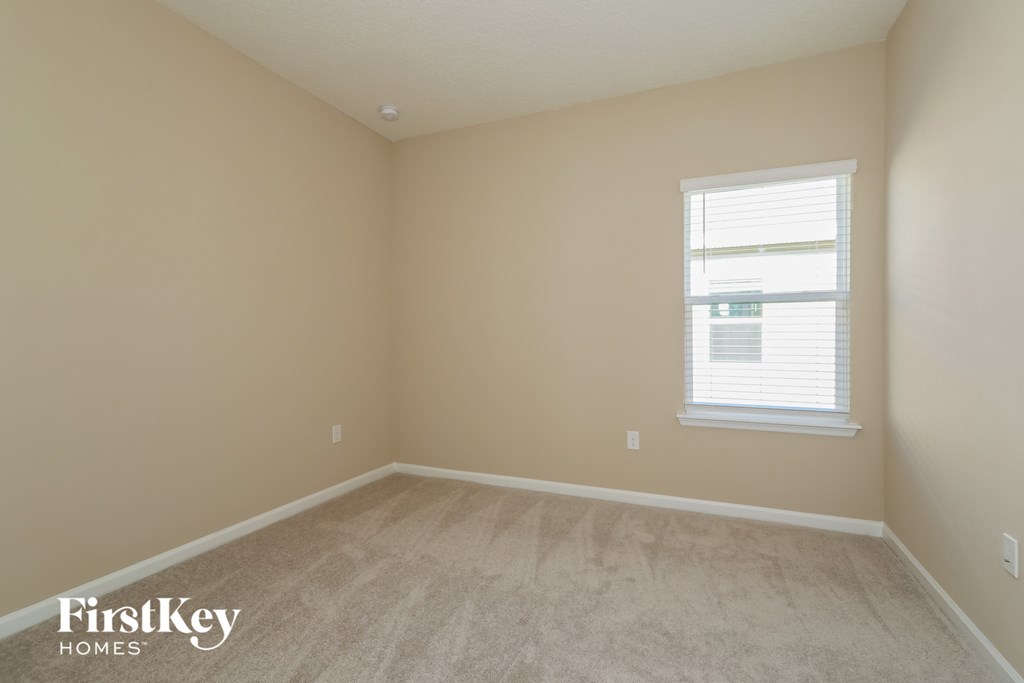a room with a carpeted floor and a window