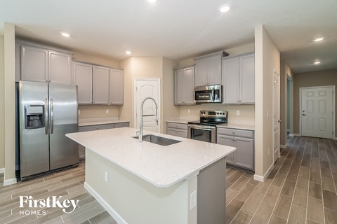a kitchen with stainless steel appliances and a white counter top
