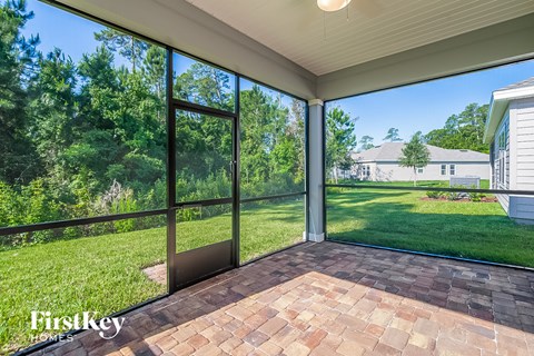 the screened porch has views of the yard and the grass