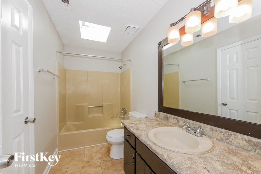 a bathroom with a sink and a shower and a toilet