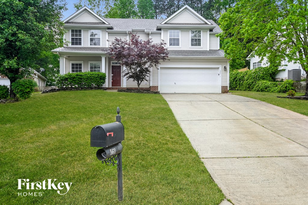 a house with a mailbox on the sidewalk in front of it