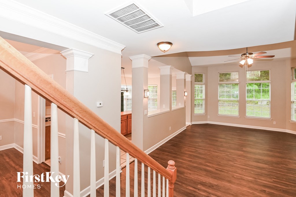 a living room with wood floors and a staircase      and a