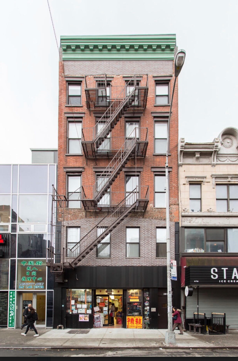 the facade of a building with a fire escape