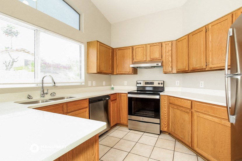a kitchen with wooden cabinets and stainless steel appliances