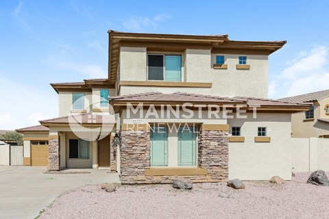 front view of a house with a garage and a driveway