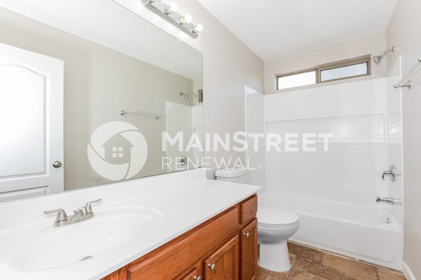 renovated bathroom for a rental property with a sink toilet and shower