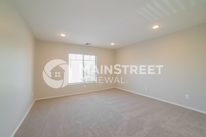 a living room with carpet and a window