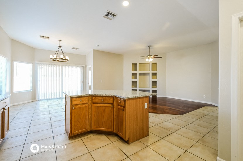 a kitchen with an island in the middle of a living room