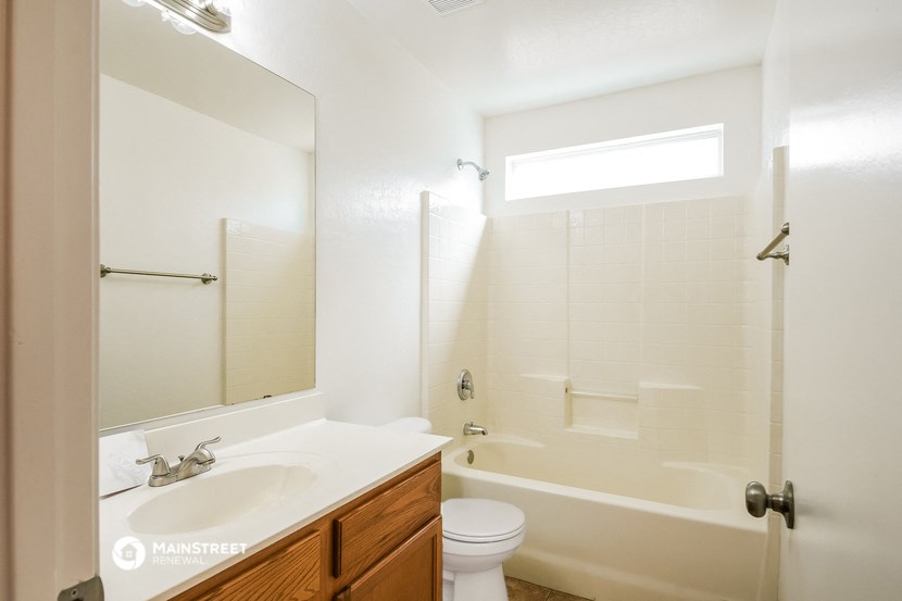 a bathroom with a shower toilet and sink and a mirror