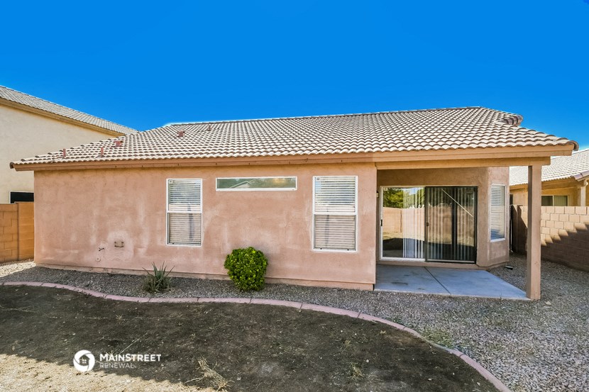 a pink house with a driveway and a garage door