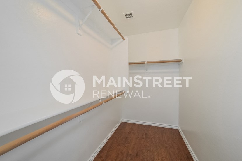 a room with a white wall and a wooden floor