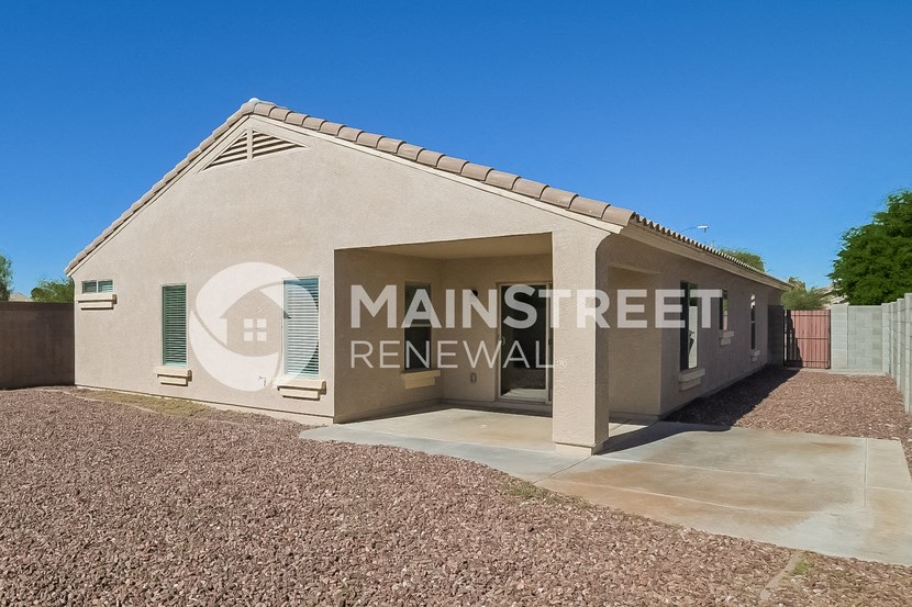 a small house with a garage and a driveway