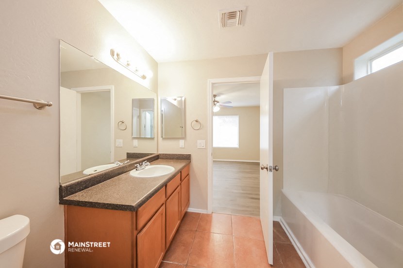 a bathroom with a sink and a shower and a bath tub