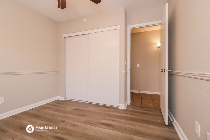 a bedroom with two closets and a door to a hallway