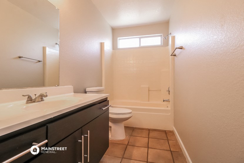 a bathroom with a toilet and a sink and a shower