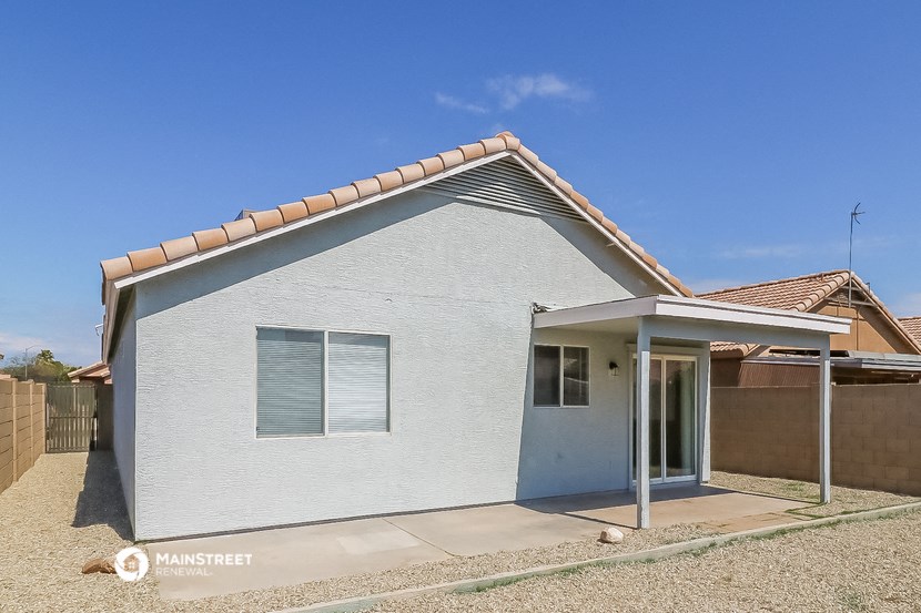 a small white house with a roof and a door