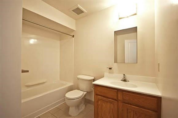 a bathroom with a toilet and a sink and a shower