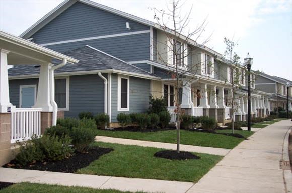a row of blue houses on a sidewalk