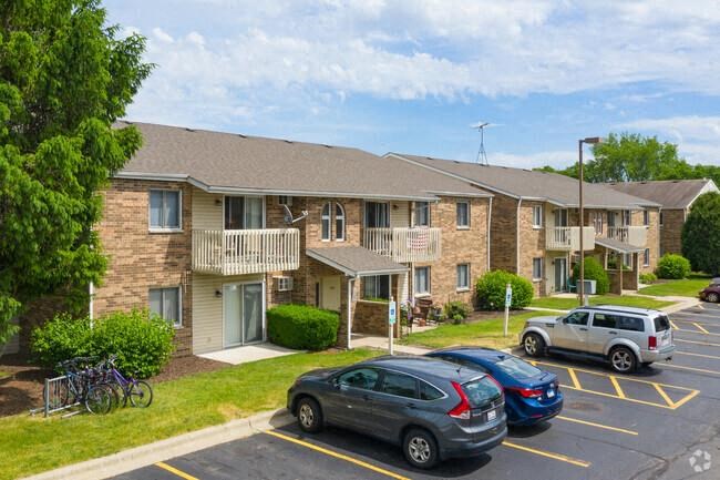 three cars parked in front of an apartment building