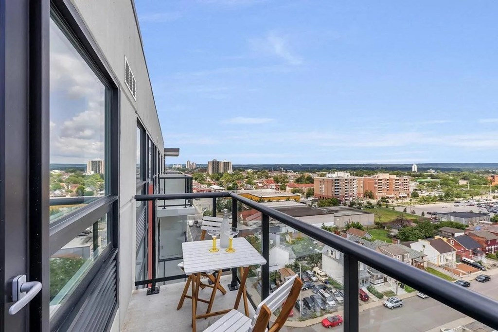 a balcony with a view of the city and the ocean