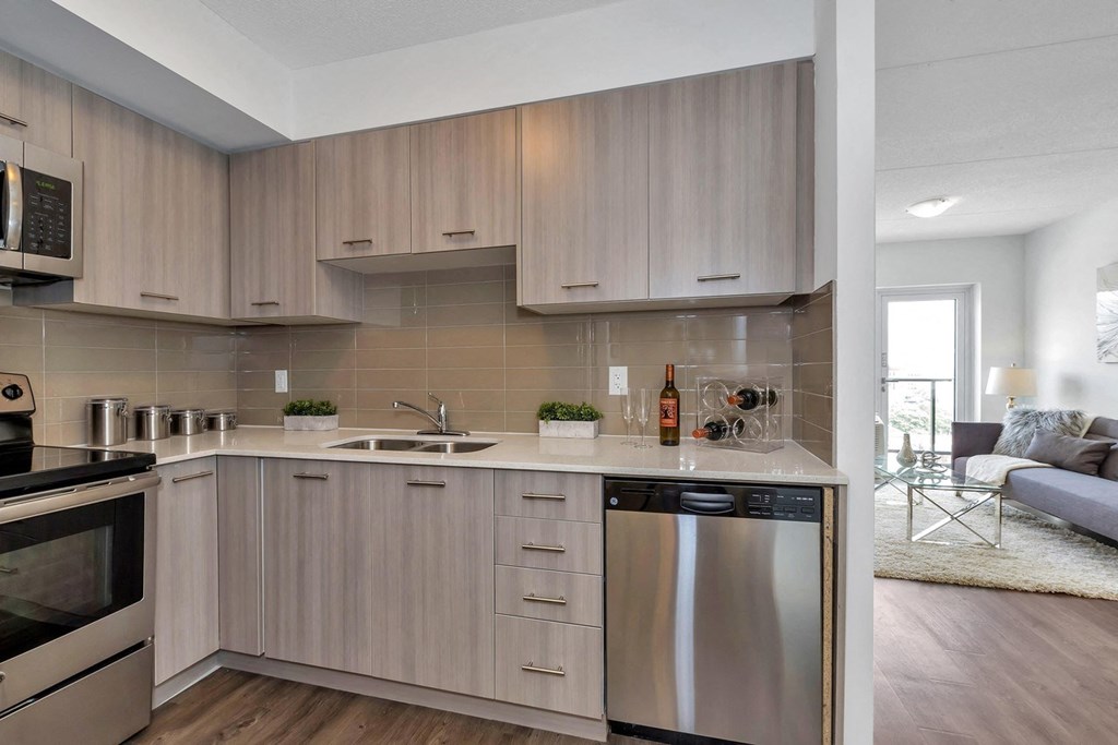 a kitchen with wooden cabinets and a stainless steel dishwasher